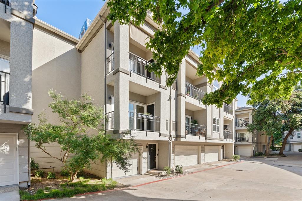 2201 Wolf Street, Unit 2106 Dallas, TX 75201 - Photo 1 of 1 a front view of a building with a garden and plants
