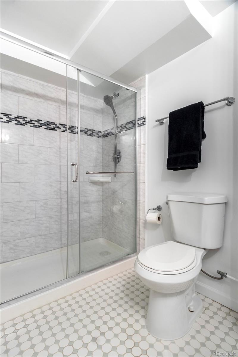 3200 Vine Street Denver, CO 80205 - Photo 23 of 31 a bathroom with a toilet and a shower