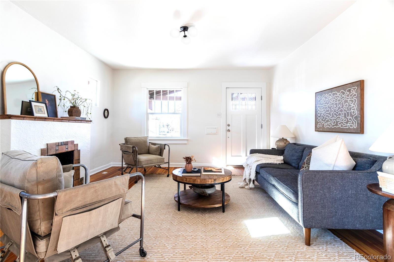 3200 Vine Street Denver, CO 80205 - Photo 3 of 31 a living room with furniture and a fireplace