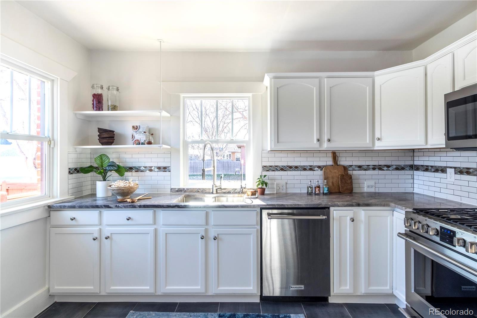 3200 Vine Street Denver, CO 80205 - Photo 6 of 31 a kitchen with granite countertop white cabinets and white appliances