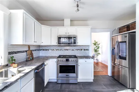 a kitchen with a stove oven and refrigerator