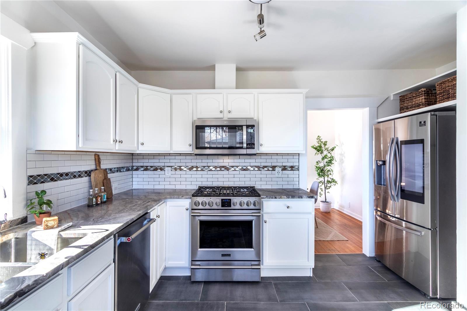 3200 Vine Street Denver, CO 80205 - Photo 7 of 31 a kitchen with a stove oven and refrigerator