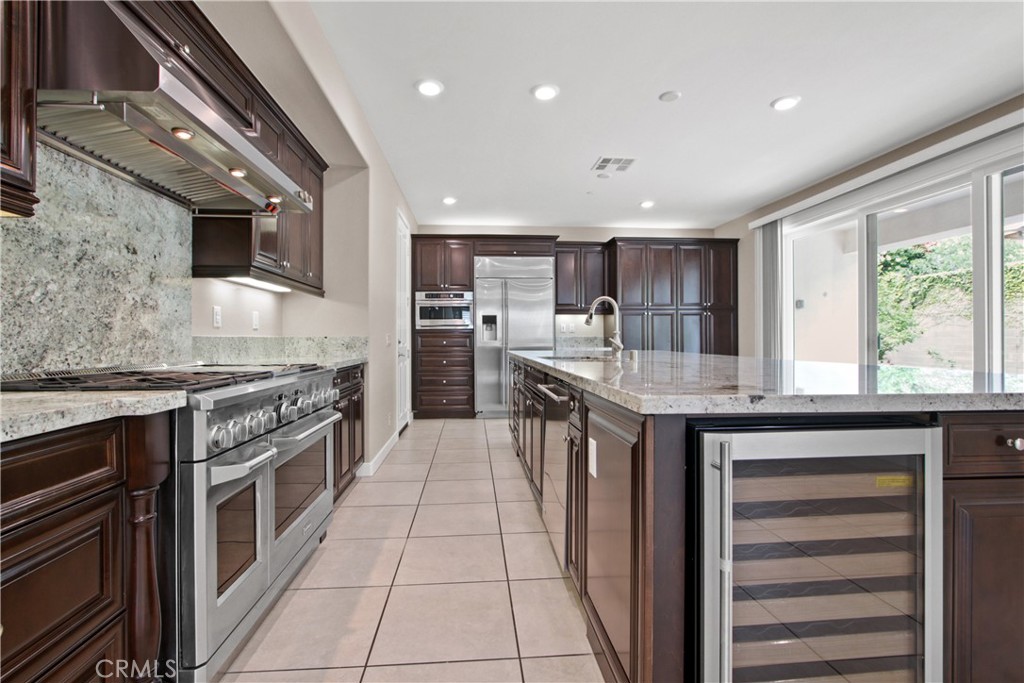 270 Radial Irvine, CA 92618 - Photo 12 of 36 a kitchen with stainless steel appliances granite countertop a stove a sink and a refrigerator