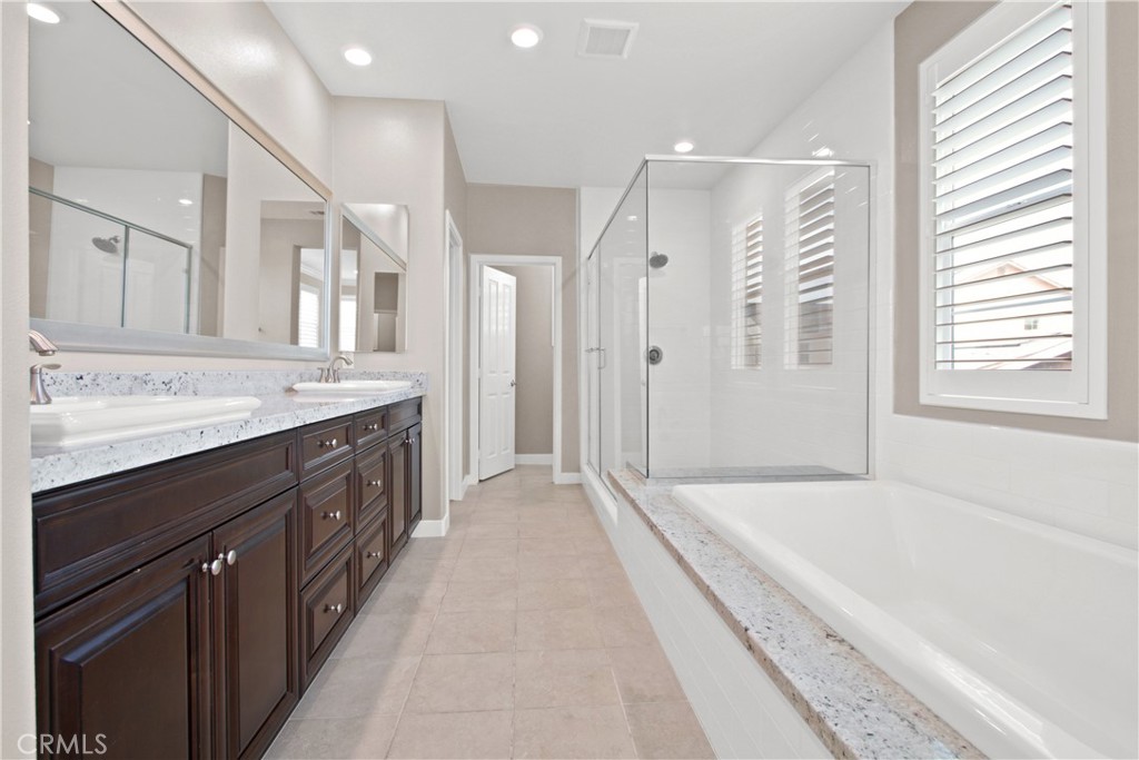 270 Radial Irvine, CA 92618 - Photo 24 of 36 a spacious bathroom with a tub sink shower and mirror
