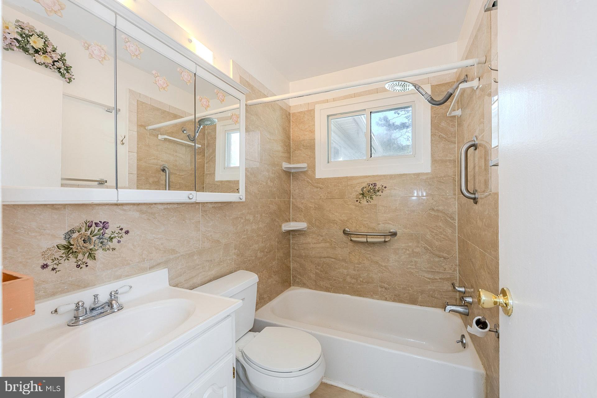 1108 Chickasaw Drive Silver Spring, MD 20903 - Photo 19 of 30 a bathroom with a sink a toilet and a bathtub