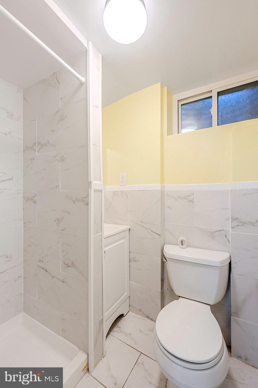 1108 Chickasaw Drive Silver Spring, MD 20903 - Photo 25 of 30 a white toilet sitting next to a bathroom sink