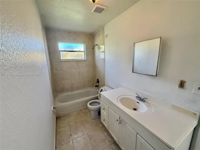 a bathroom with a sink a bathtub and a shower