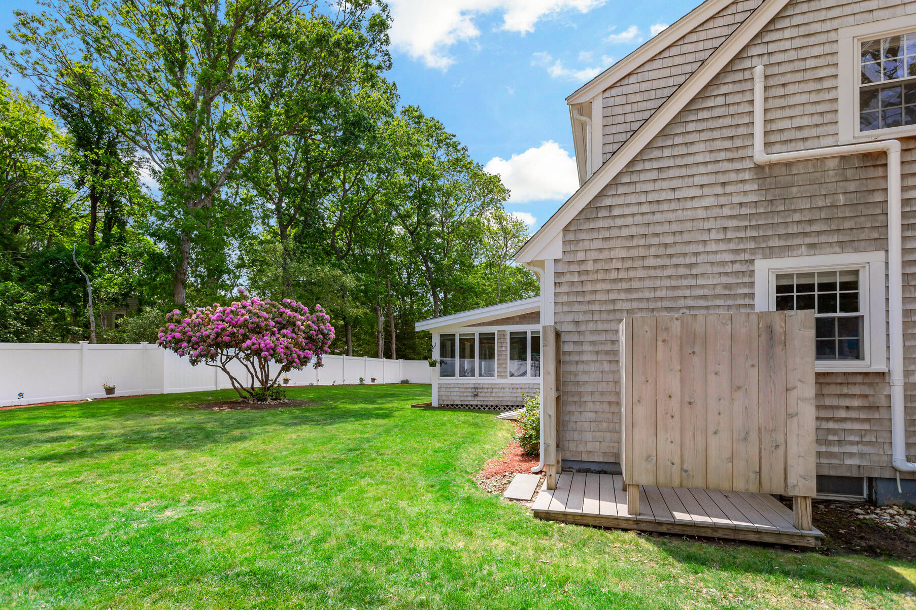 50 Deerfield Road Osterville, MA 02655 - Photo 24 of 32 a view of a house with a yard and sitting area