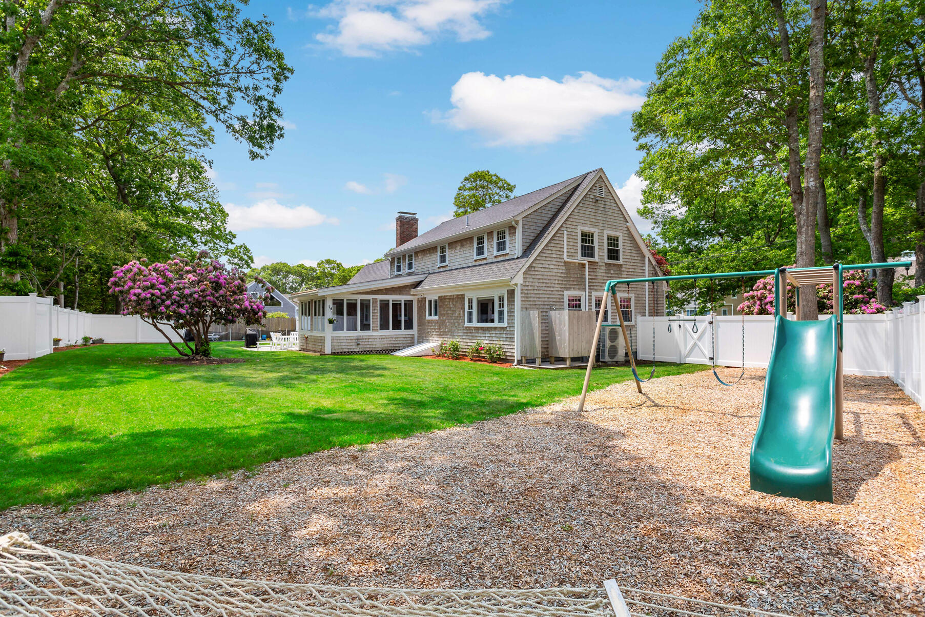 50 Deerfield Road Osterville, MA 02655 - Photo 25 of 32 a view of a house with a back yard