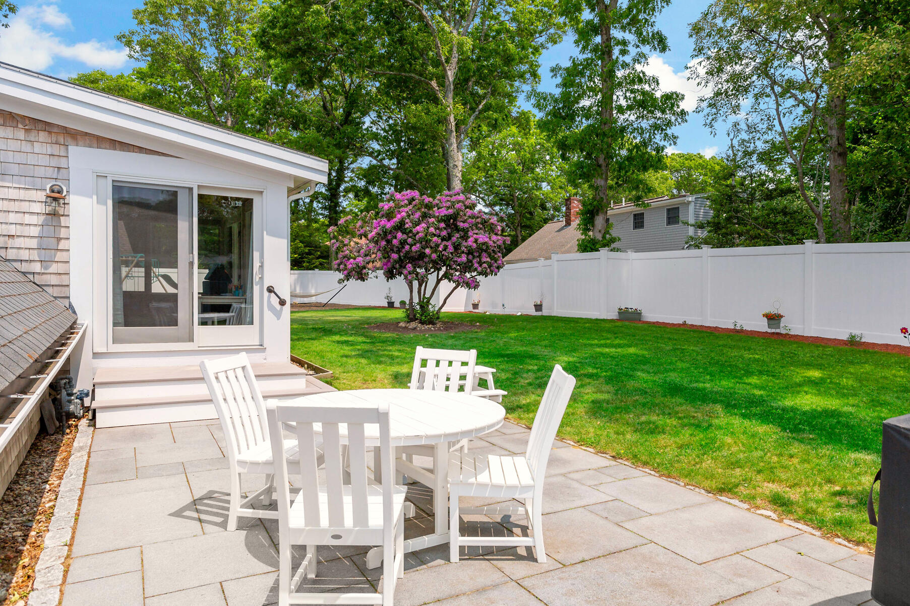 50 Deerfield Road Osterville, MA 02655 - Photo 29 of 32 a view of a chairs and table in backyard of the house