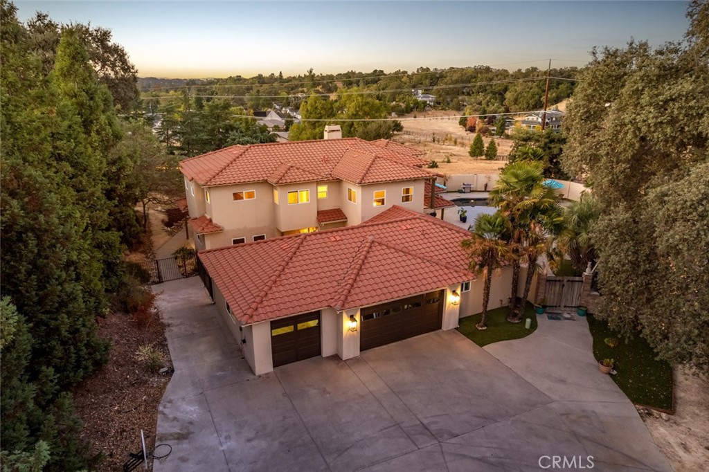 an aerial view of a house with a yard and balcony