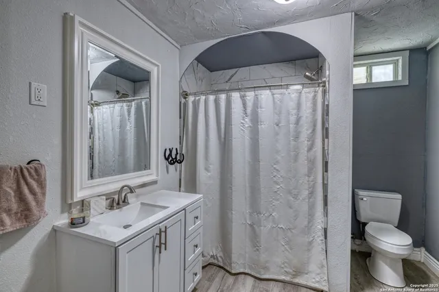 a bathroom with a sink toilet and shower