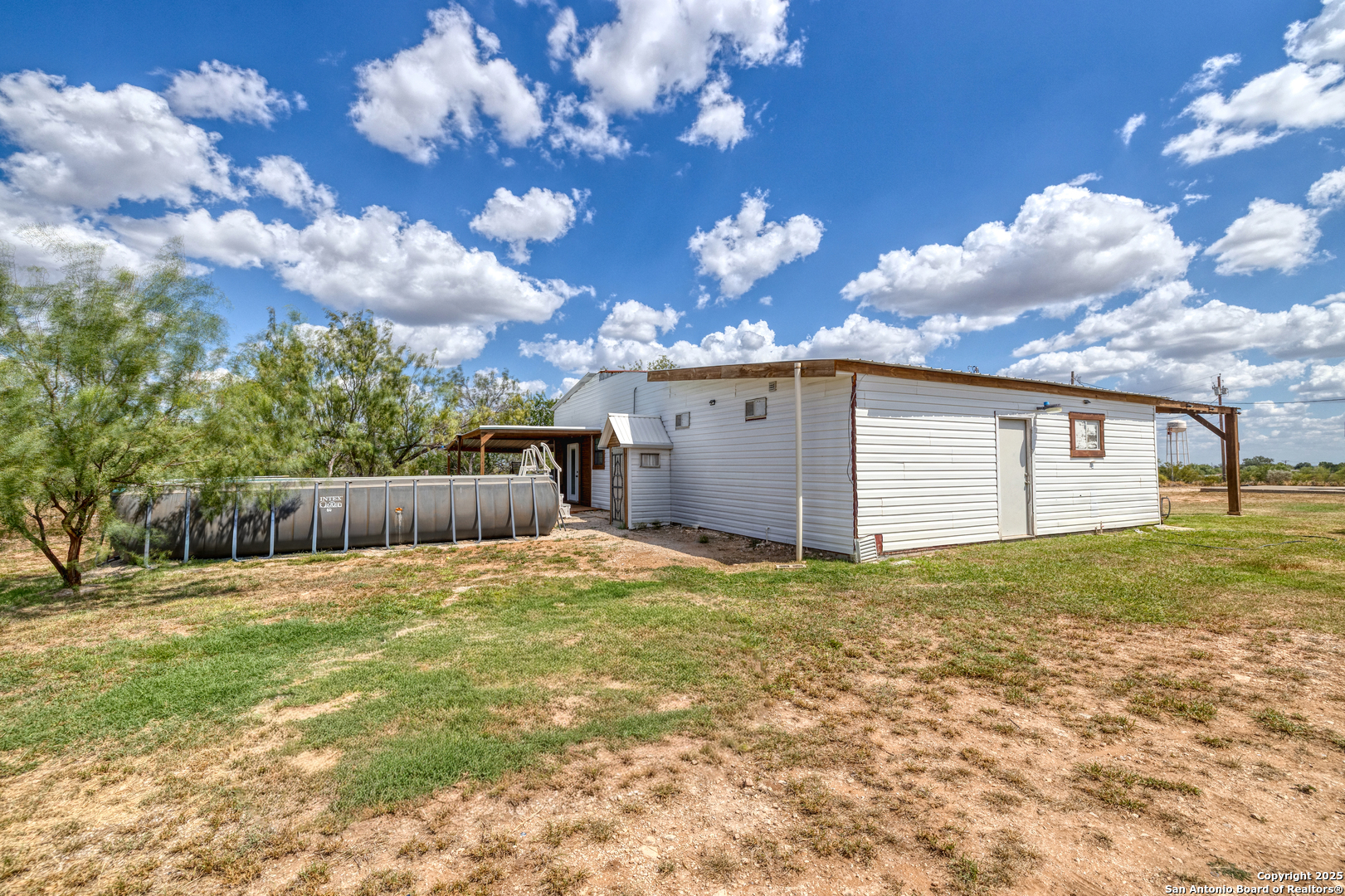 152 John Ayers Road Carrizo Springs, TX 78834 - Photo 2 of 14 a backyard of a house with lots of green space