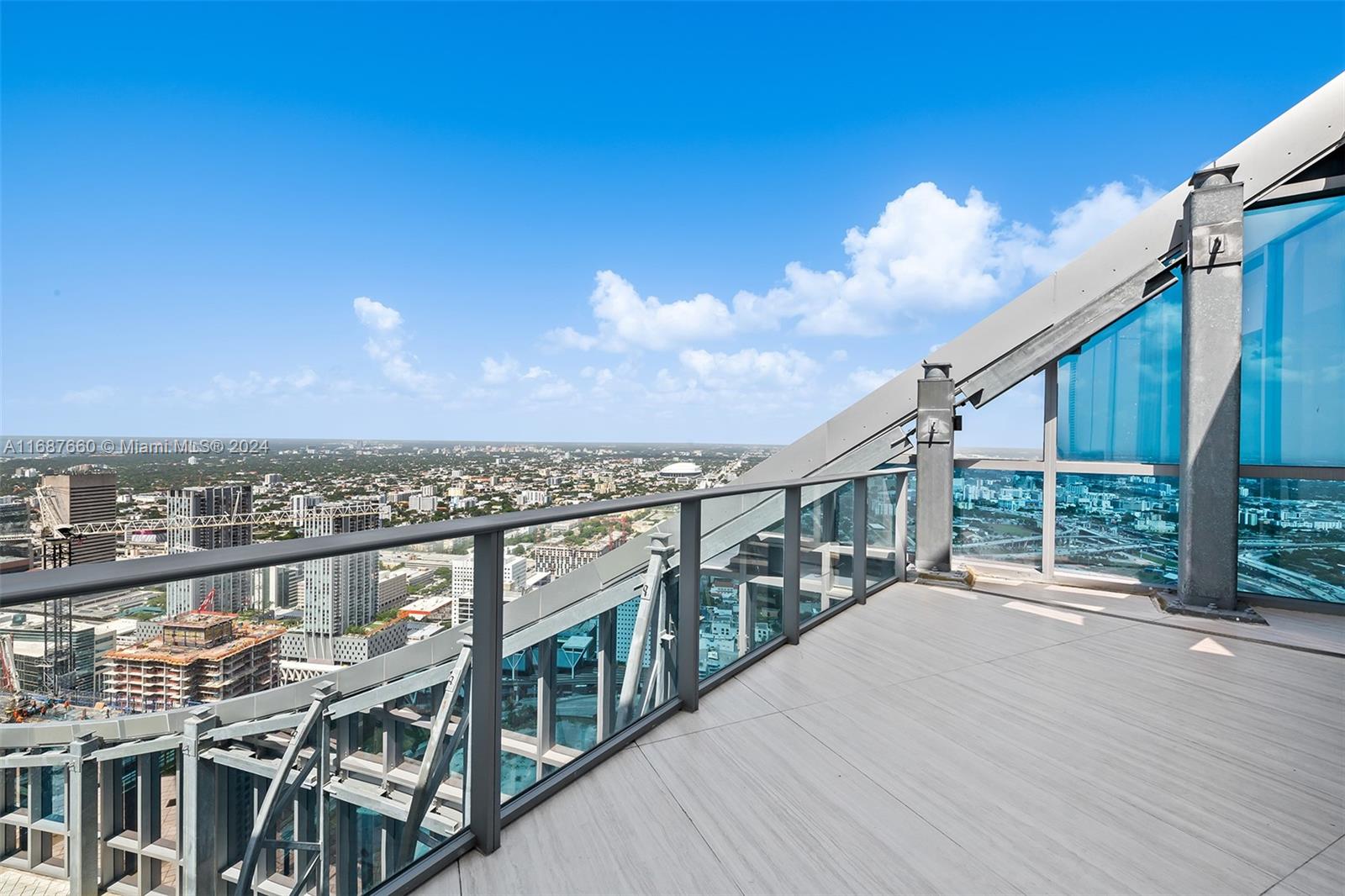 851 Northeast 1st Avenue, Unit PH5700 Miami, FL 33132 - Photo 12 of 91 a view of a terrace with wooden floor and city view