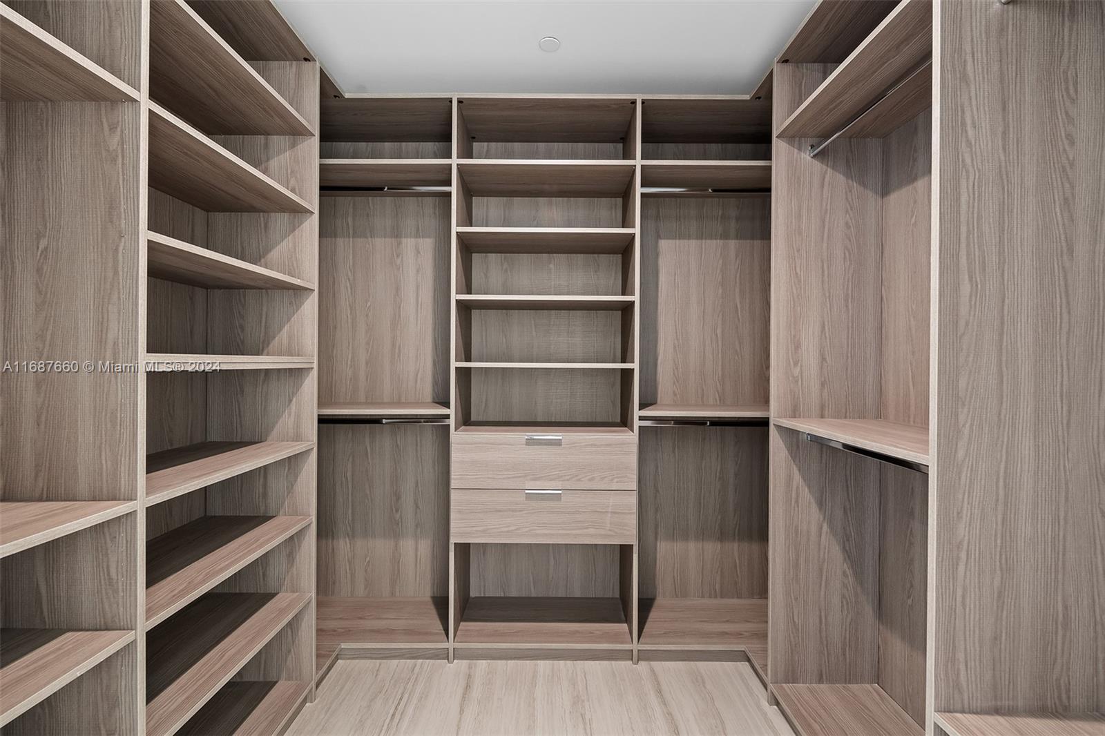 851 Northeast 1st Avenue, Unit PH5700 Miami, FL 33132 - Photo 16 of 91 a view of walk in closet with empty racks