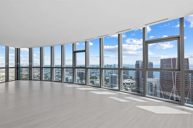 a view of wooden floor and windows in a room