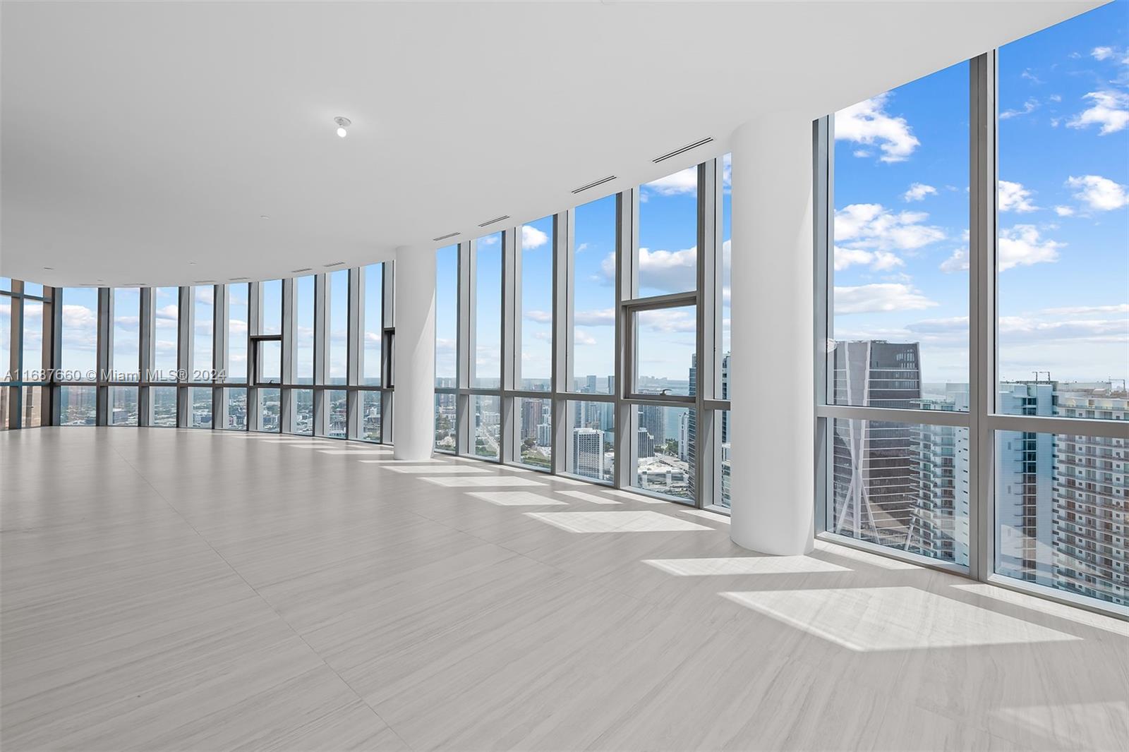 851 Northeast 1st Avenue, Unit PH5700 Miami, FL 33132 - Photo 34 of 91 a view of an empty room with wooden floor and a window