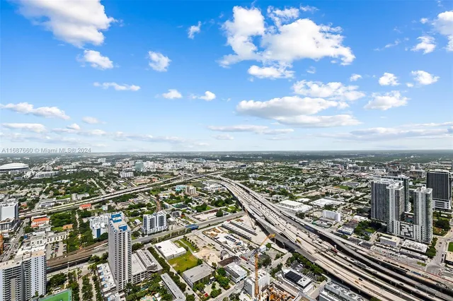 a bedroom with bed and a large mirror