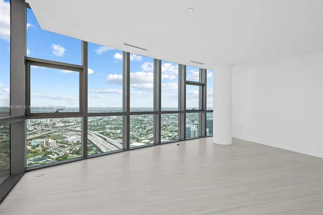 a view of an empty room with windows