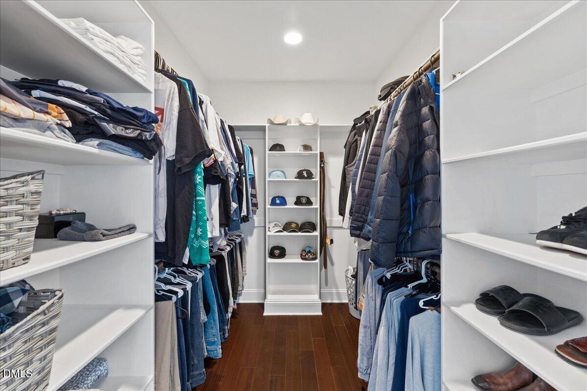 1304 Flying Hawk Road Apex, NC 27523 - Photo 21 of 52 a view of walk in closet with clothes and shoes