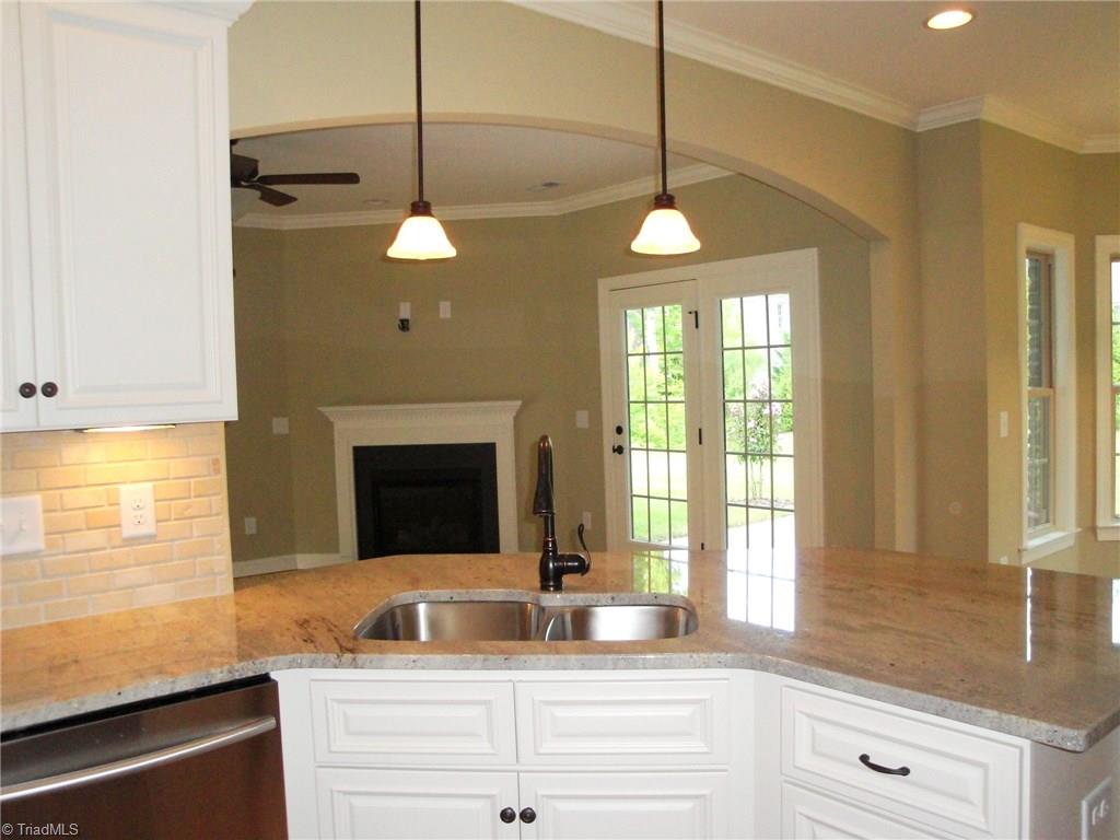 2230 Renaissance Lane High Point, NC 27262 - Photo 7 of 25 Crisp white cabinets, hand picked granite and custom tile backsplash set the Kitchen apart!