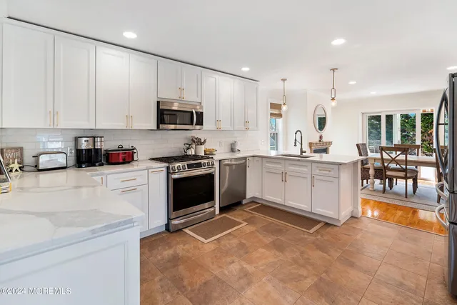 a kitchen with stainless steel appliances a stove sink and cabinets