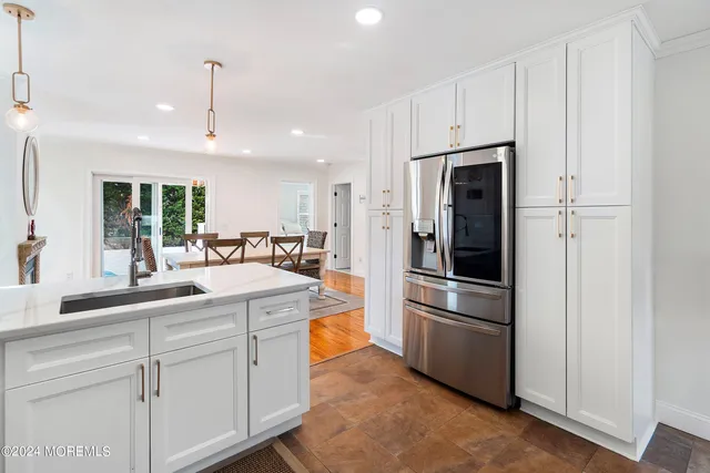 a kitchen with stainless steel appliances a refrigerator sink and stove