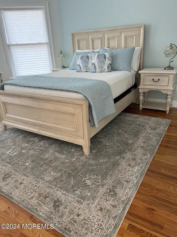 a bedroom with a bed and a rug