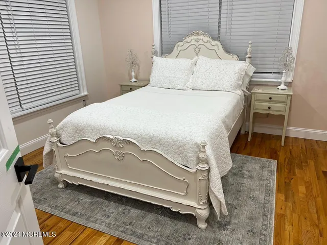 a bedroom with a bed and mirror on the side