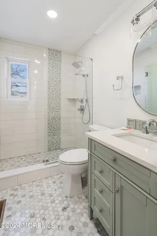 a bathroom with a granite countertop toilet sink and mirror