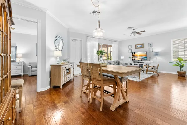 a living room with dining room and wooden floor