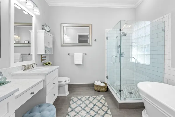 a bathroom with a sink a toilet and shower