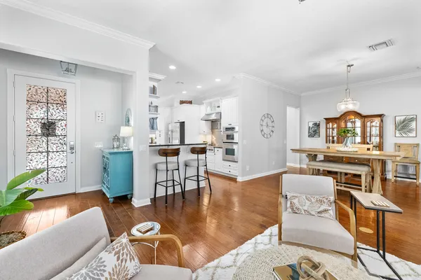 a living room with furniture and kitchen view