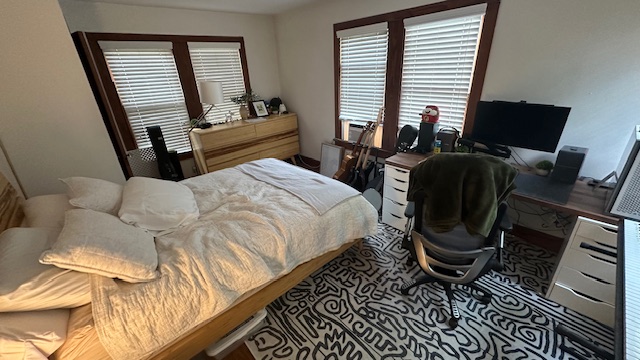 906 West 22nd Street, Unit 4 Austin, TX 78705 - Photo 5 of 7 a bedroom with a bed and wooden floor
