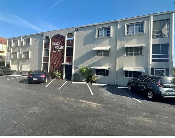 a view of a building with car parked