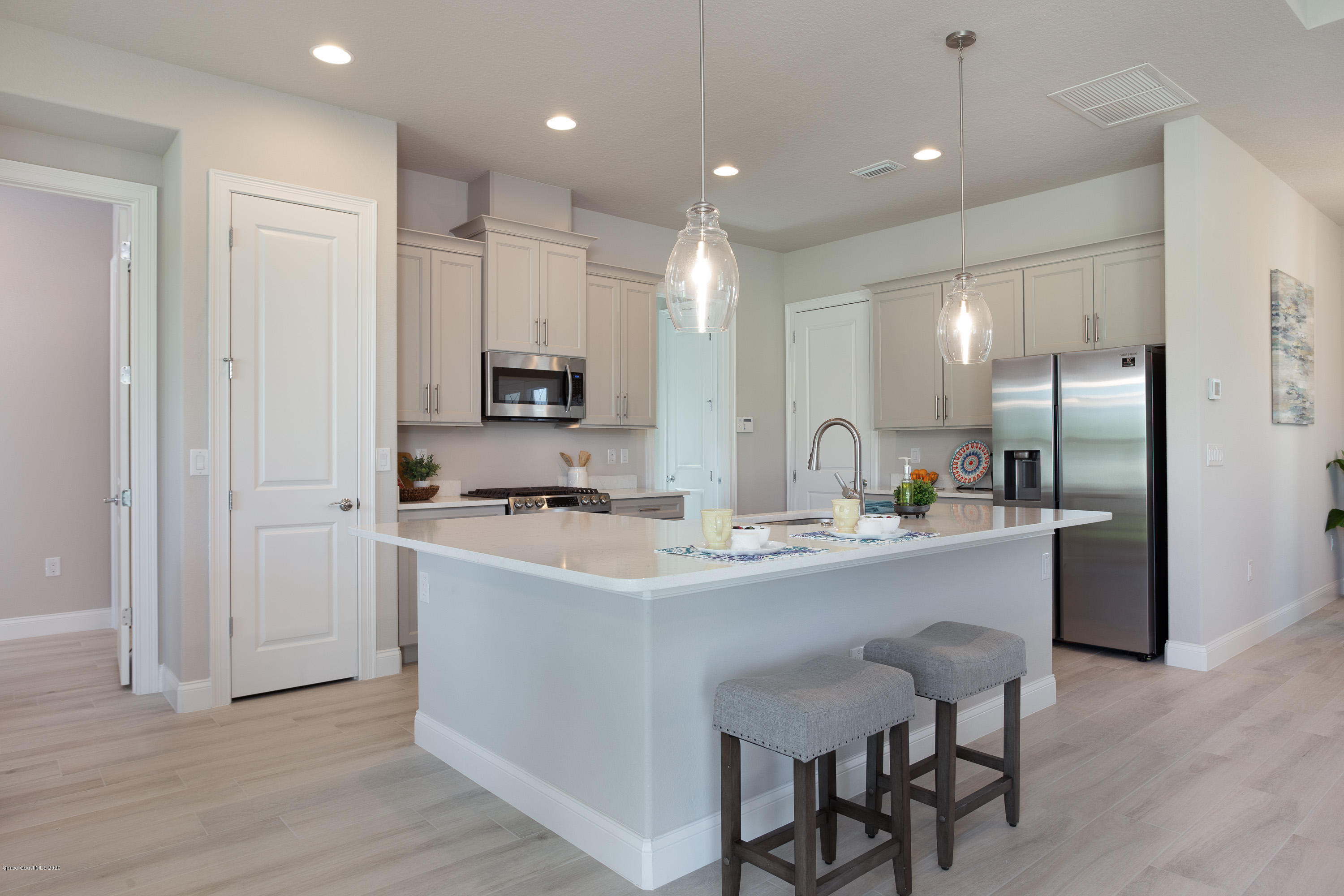 4435 Negal Circle Melbourne, FL 32901 - Photo 11 of 33 a kitchen with refrigerator a sink and chairs