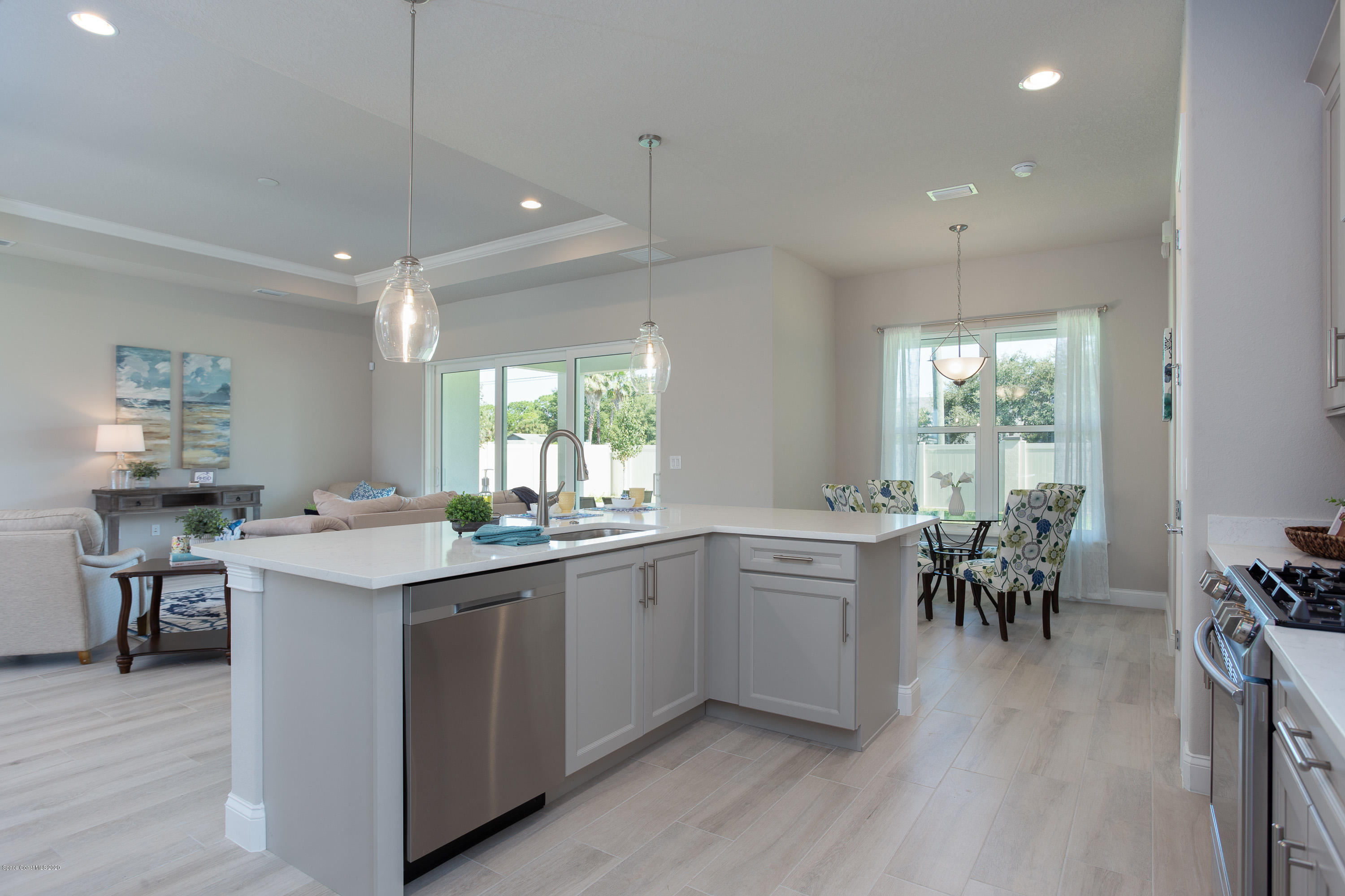 4435 Negal Circle Melbourne, FL 32901 - Photo 16 of 33 a kitchen with a sink dining table and chairs