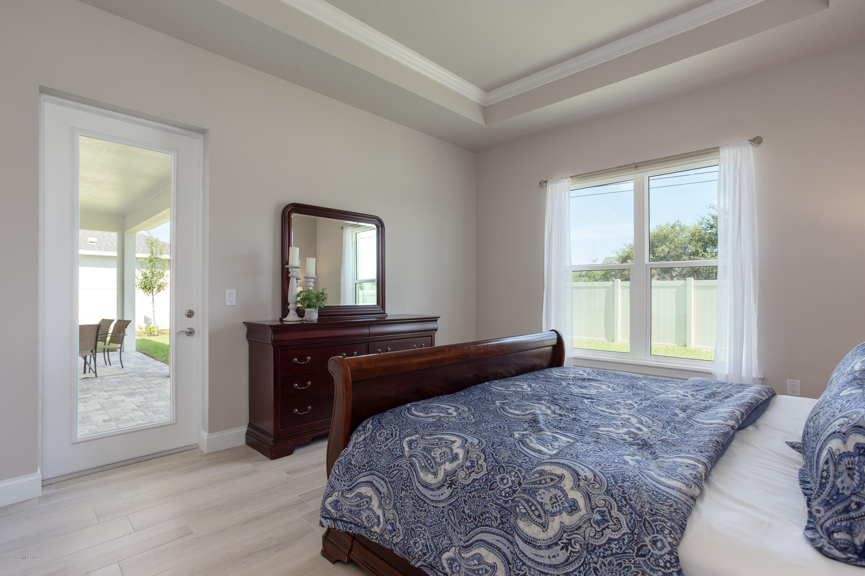 4435 Negal Circle Melbourne, FL 32901 - Photo 18 of 33 a bedroom with a bed and wooden floor