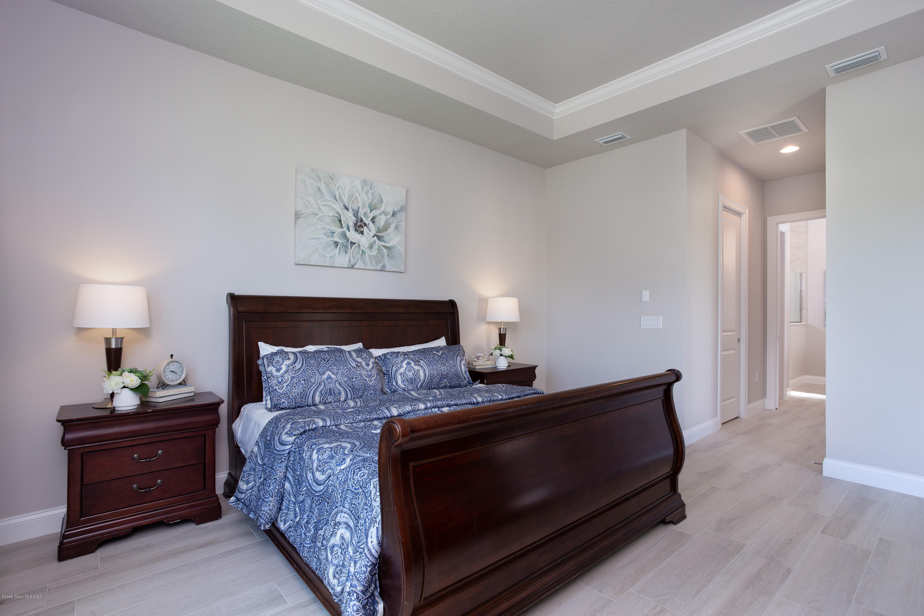 4435 Negal Circle Melbourne, FL 32901 - Photo 19 of 33 a bed room with a bed and a night stand