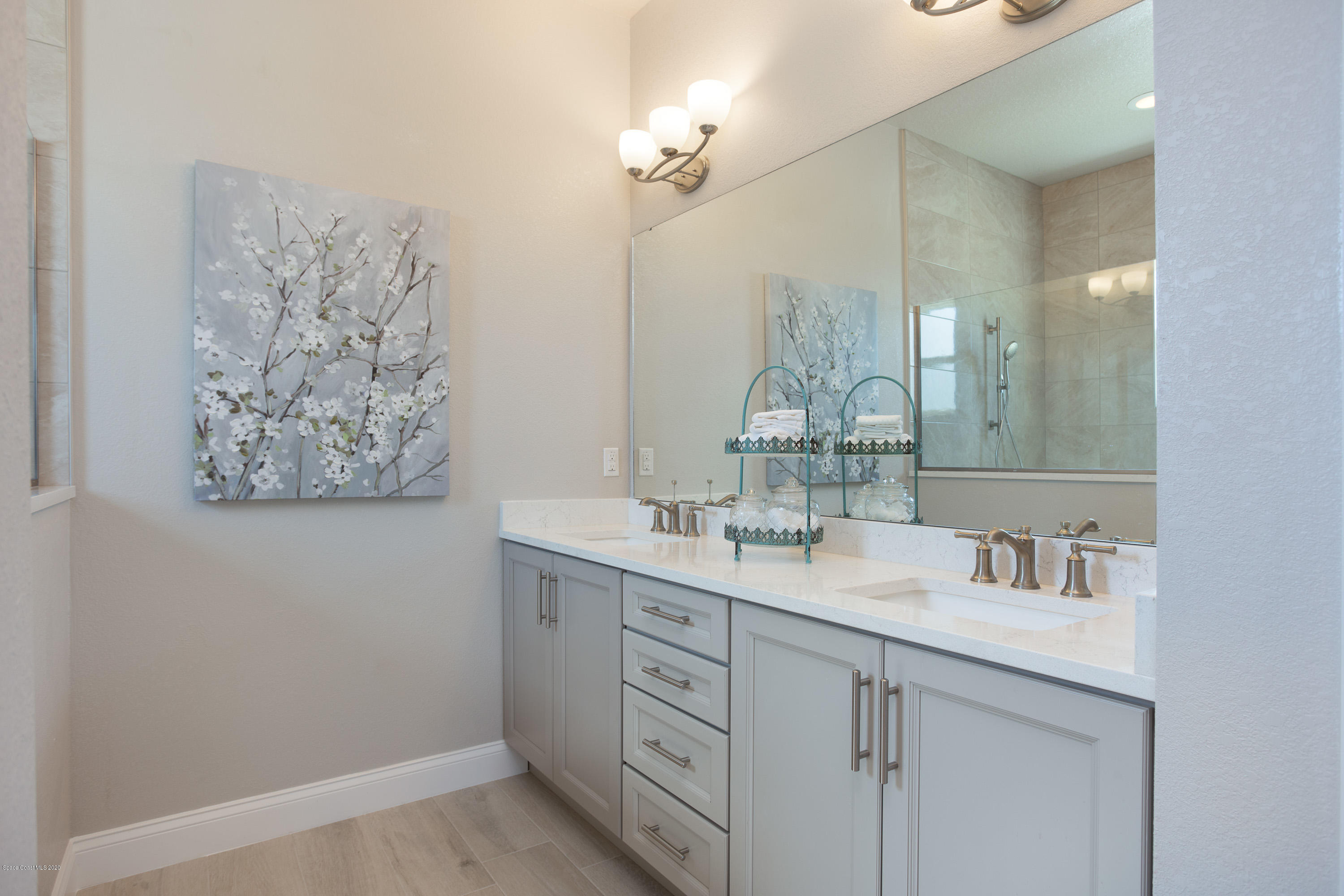 4435 Negal Circle Melbourne, FL 32901 - Photo 20 of 33 a bathroom with a sink vanity and a mirror