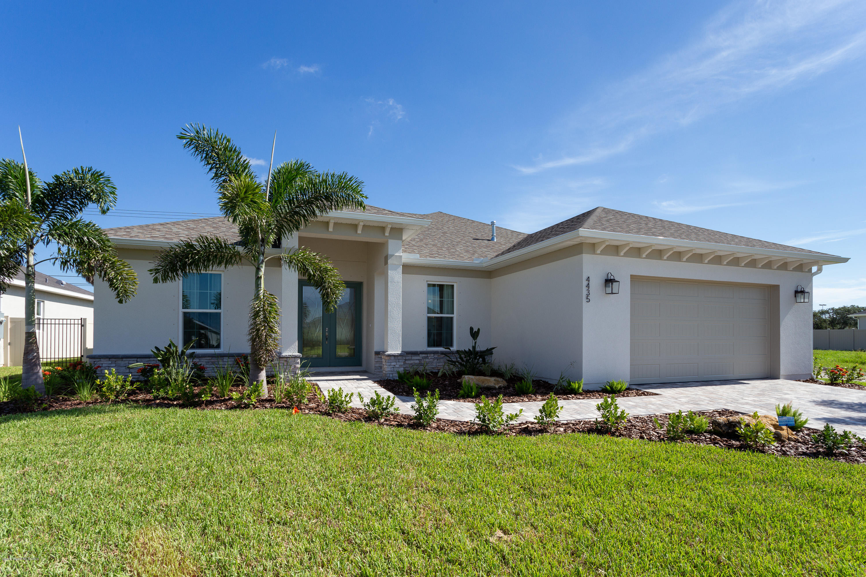 4435 Negal Circle Melbourne, FL 32901 - Photo 2 of 33 a front view of a house with a garden and plants