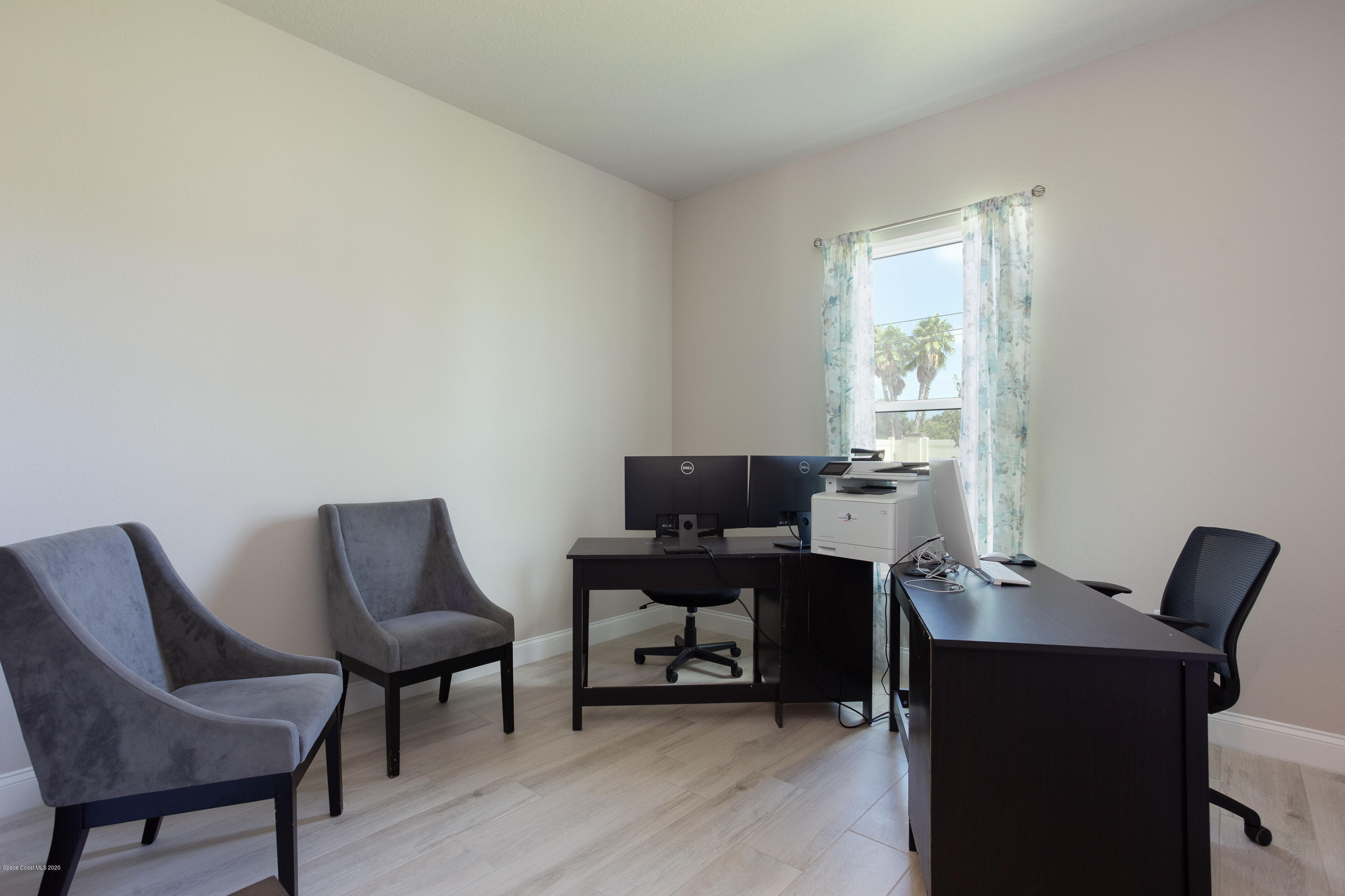 4435 Negal Circle Melbourne, FL 32901 - Photo 25 of 33 a view of a workspace with furniture and a window