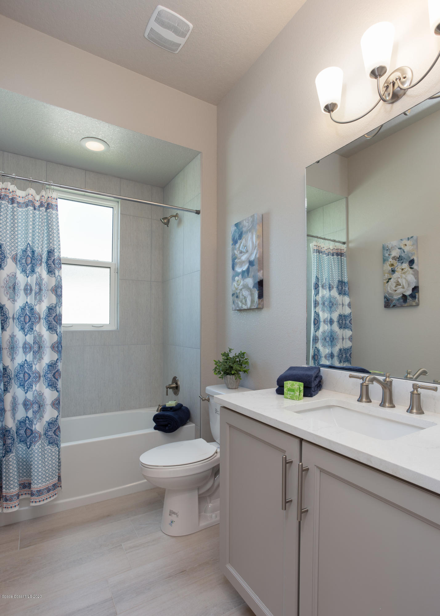 4435 Negal Circle Melbourne, FL 32901 - Photo 26 of 33 a bathroom with a sink toilet a mirror and shower