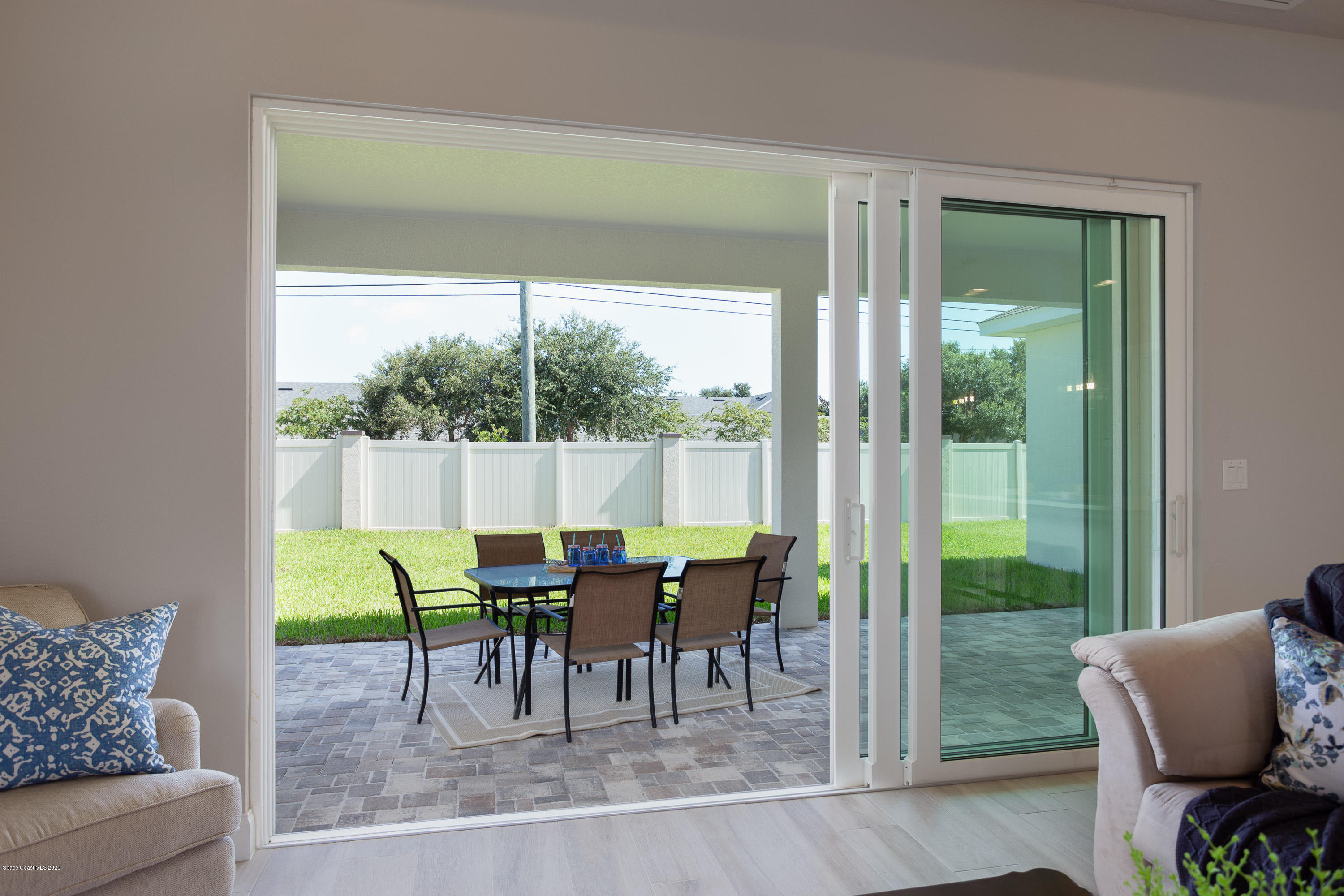 4435 Negal Circle Melbourne, FL 32901 - Photo 9 of 33 a dining room with furniture and a floor to ceiling window