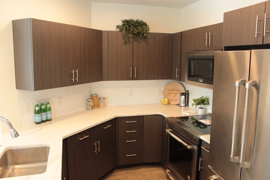 20 Penniman Road, Unit 108 Boston, MA 02134 - Photo 2 of 14 a kitchen with a sink and a refrigerator