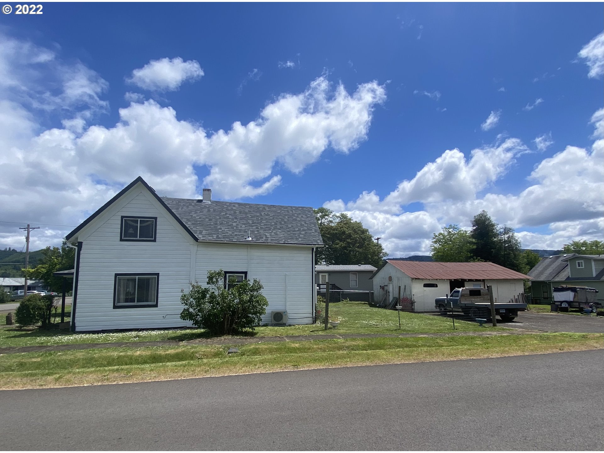 296 Applegate Street Yoncalla, OR 97499 - Photo 5 of 18 a view of a house with a cars park next to a yard