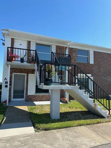 a view of house with swimming pool outdoor seating