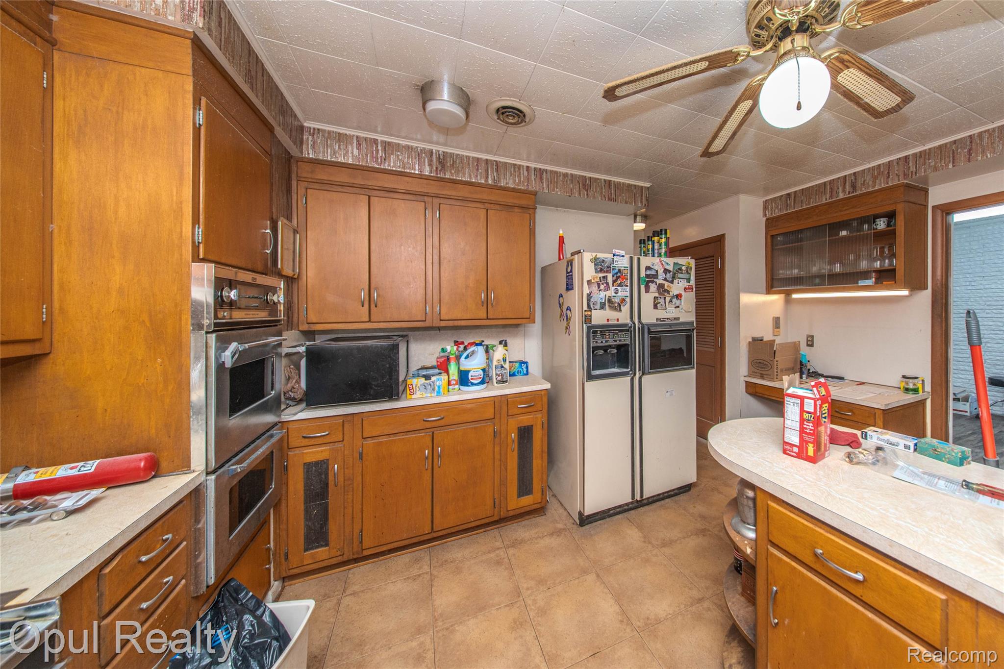 6455 Norham Road Bloomfield Hills, MI 48301 - Photo 36 of 93 Wood-finish cabinetry and light-toned countertops define this kitchen space