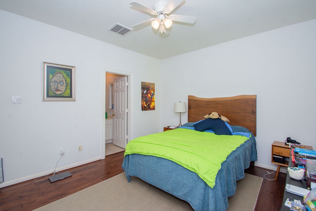 3011 Bonnebridge Way Boulevard Houston, TX 77082 - Photo 29 of 45 a bedroom with a bed and a chandelier