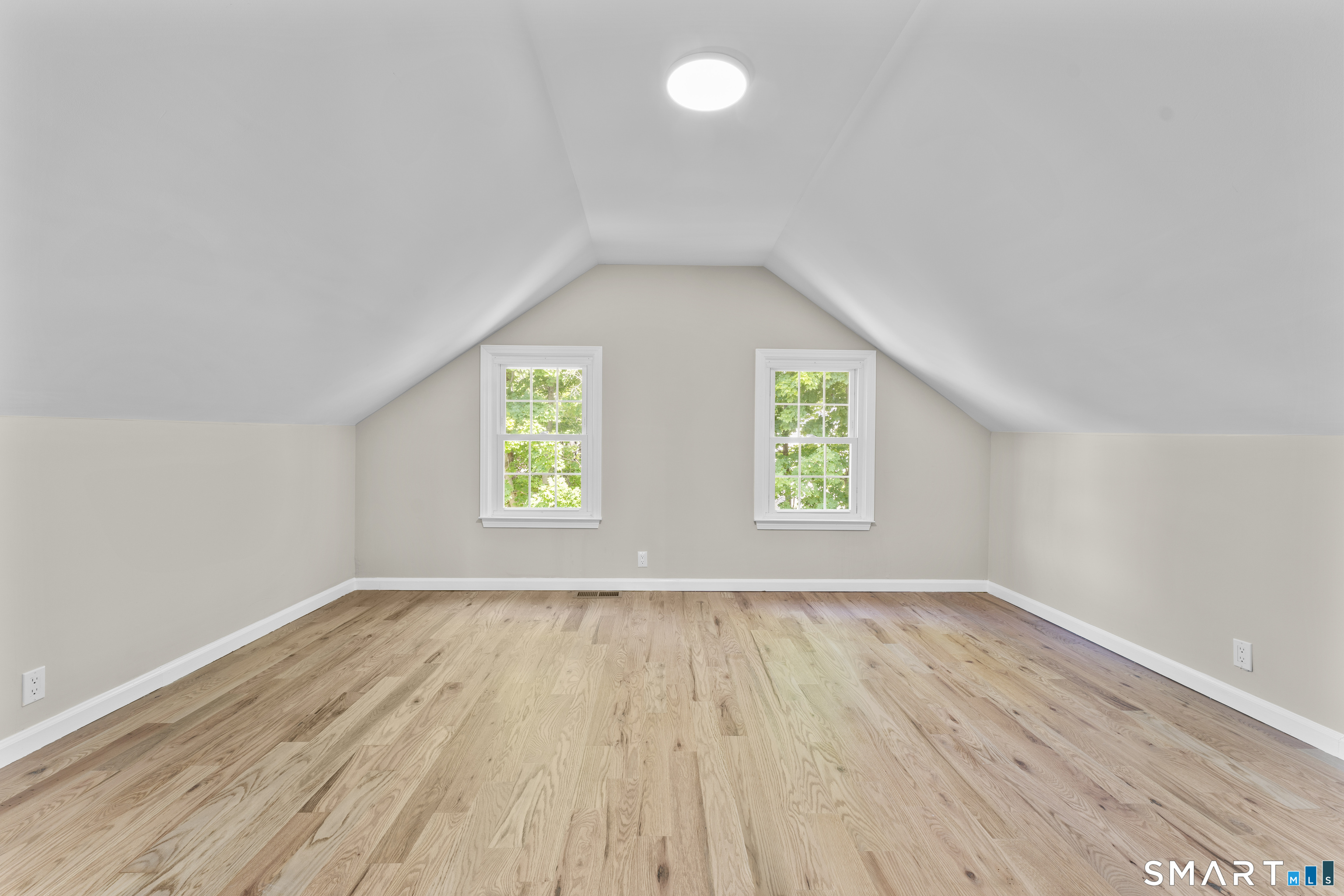 110 Minturn Road Bridgeport, CT 06606 - Photo 22 of 29 an empty room with wooden floor and windows